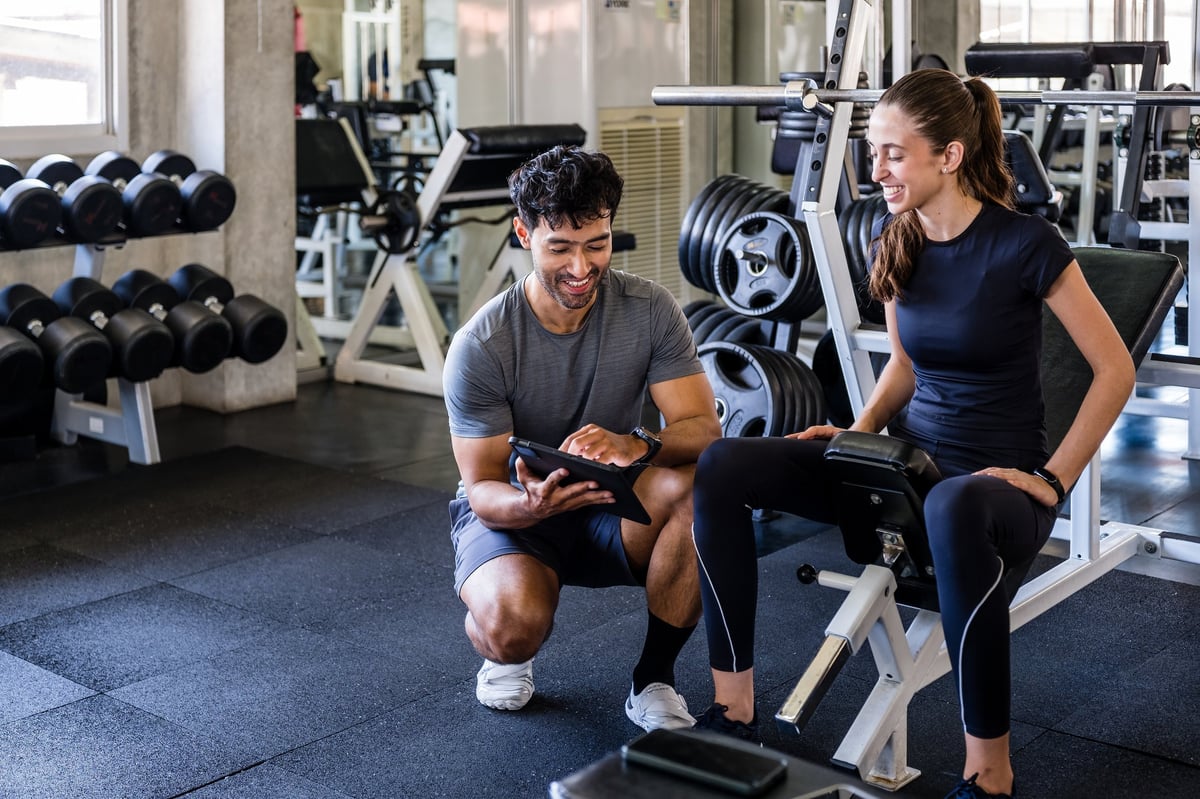 Professional training environment — performance specialist reviewing session data with an athlete