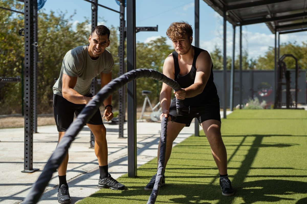 Strength and conditioning work with battle ropes at an outdoor training facility